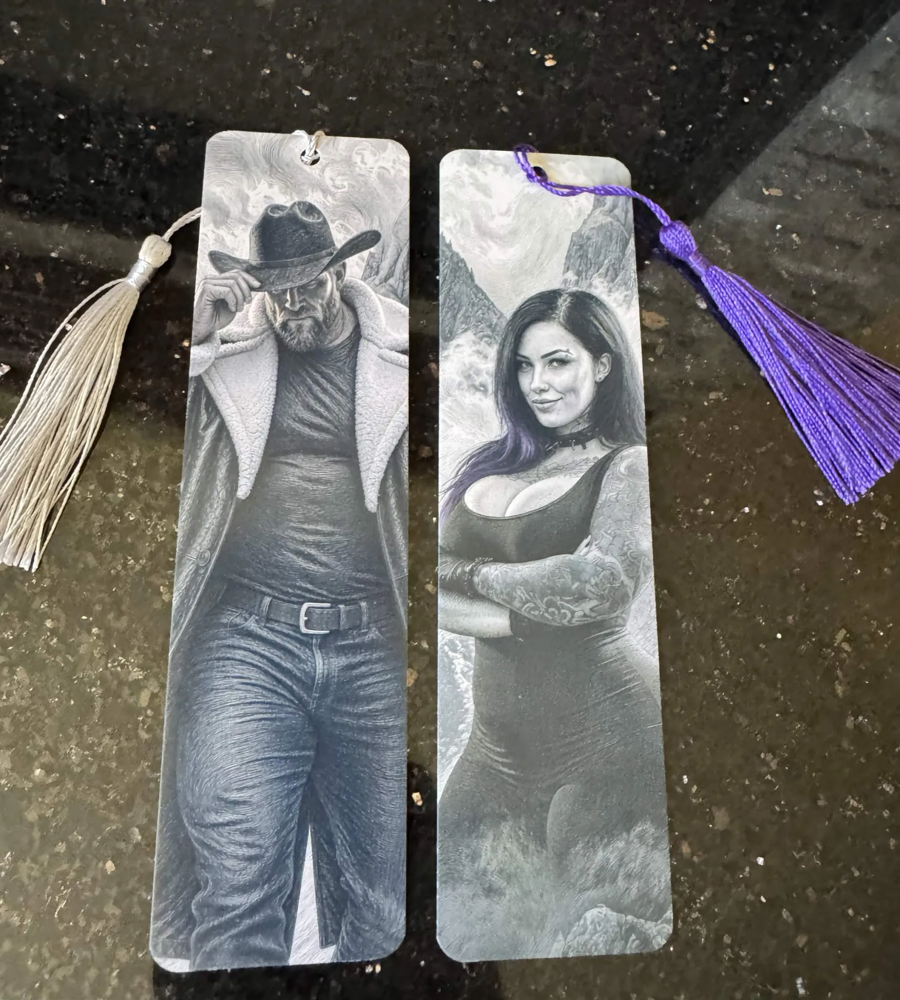 Cal and Sage bookmarks side by side, with silver and purple tassels.